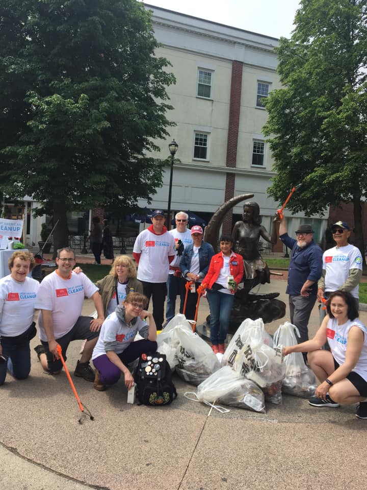 William Legault posing alongside the Keep Salem Beautiful Group in front of Samantha the Witch Statue while cleaning up Trash